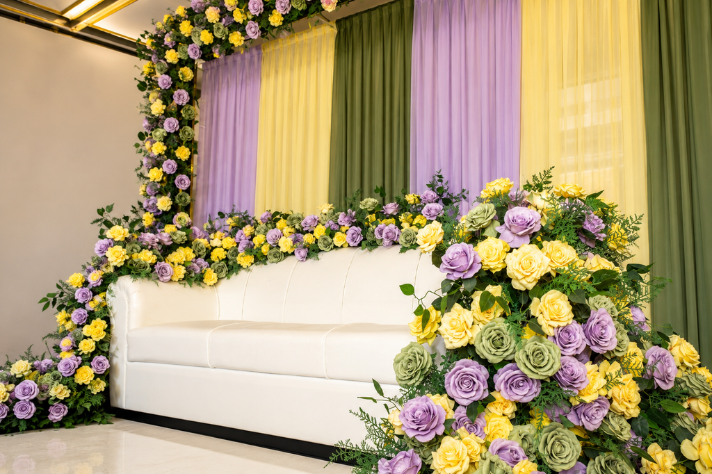 Lavender and yellow floral lounge stage with white sofa, side angle